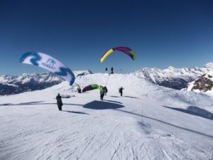 Skiing in Verbier - skiers and parachutes